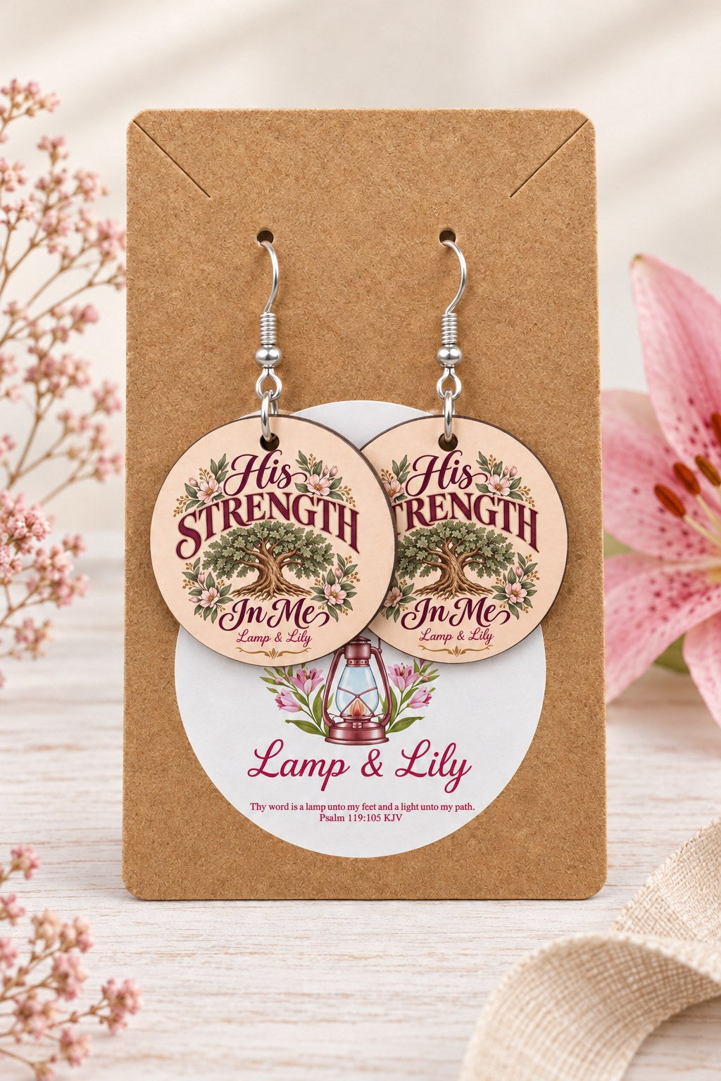 His Strength in Me round Lamp & Lily earrings on silver hooks displayed on a kraft earring card