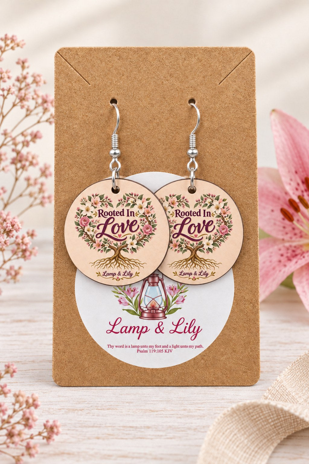 Rooted in Love round Lamp & Lily earrings on silver hooks displayed on a kraft earring card