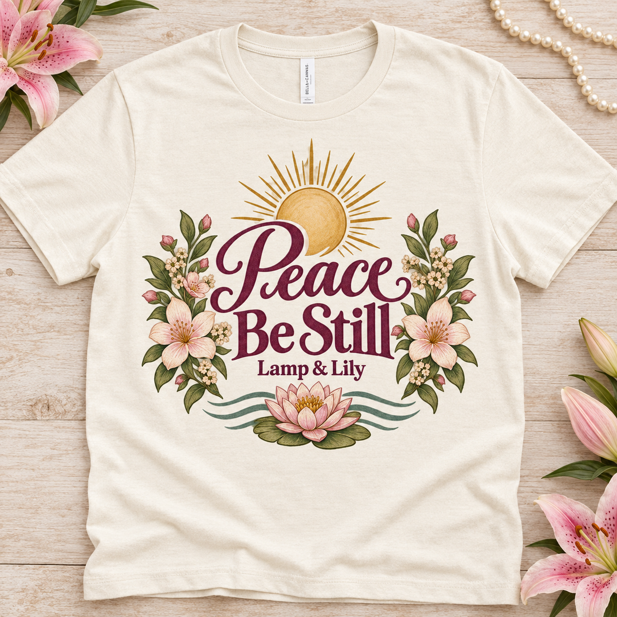 Peace Be Still Lamp & Lily tee with a floral faith design, inspired by Isaiah 26:3