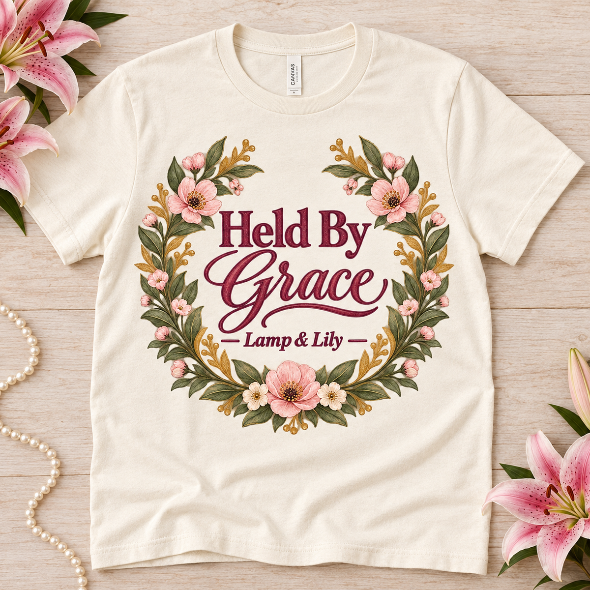 Held by Grace Lamp & Lily tee with a floral faith design, inspired by Psalm 73:23