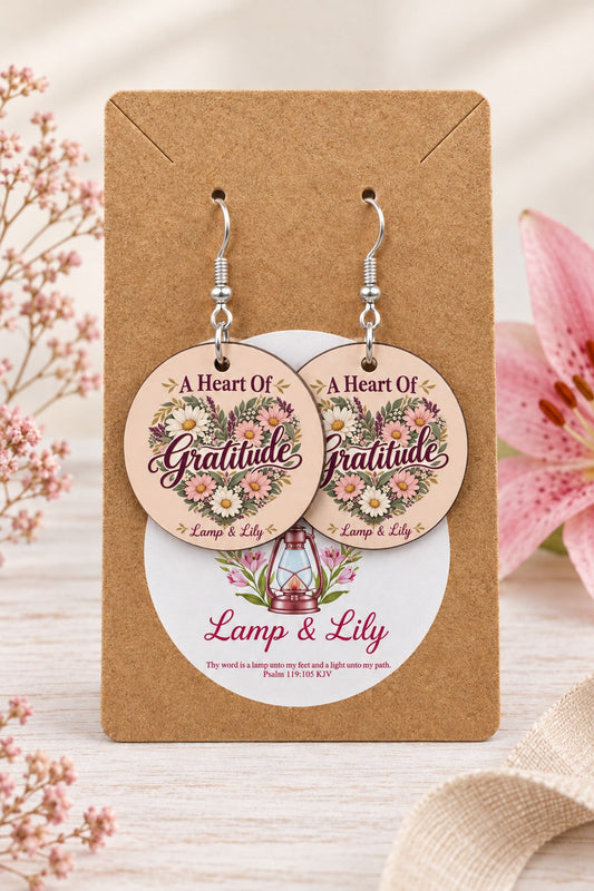 A Heart of Gratitude round Lamp & Lily earrings on silver hooks displayed on a kraft earring card