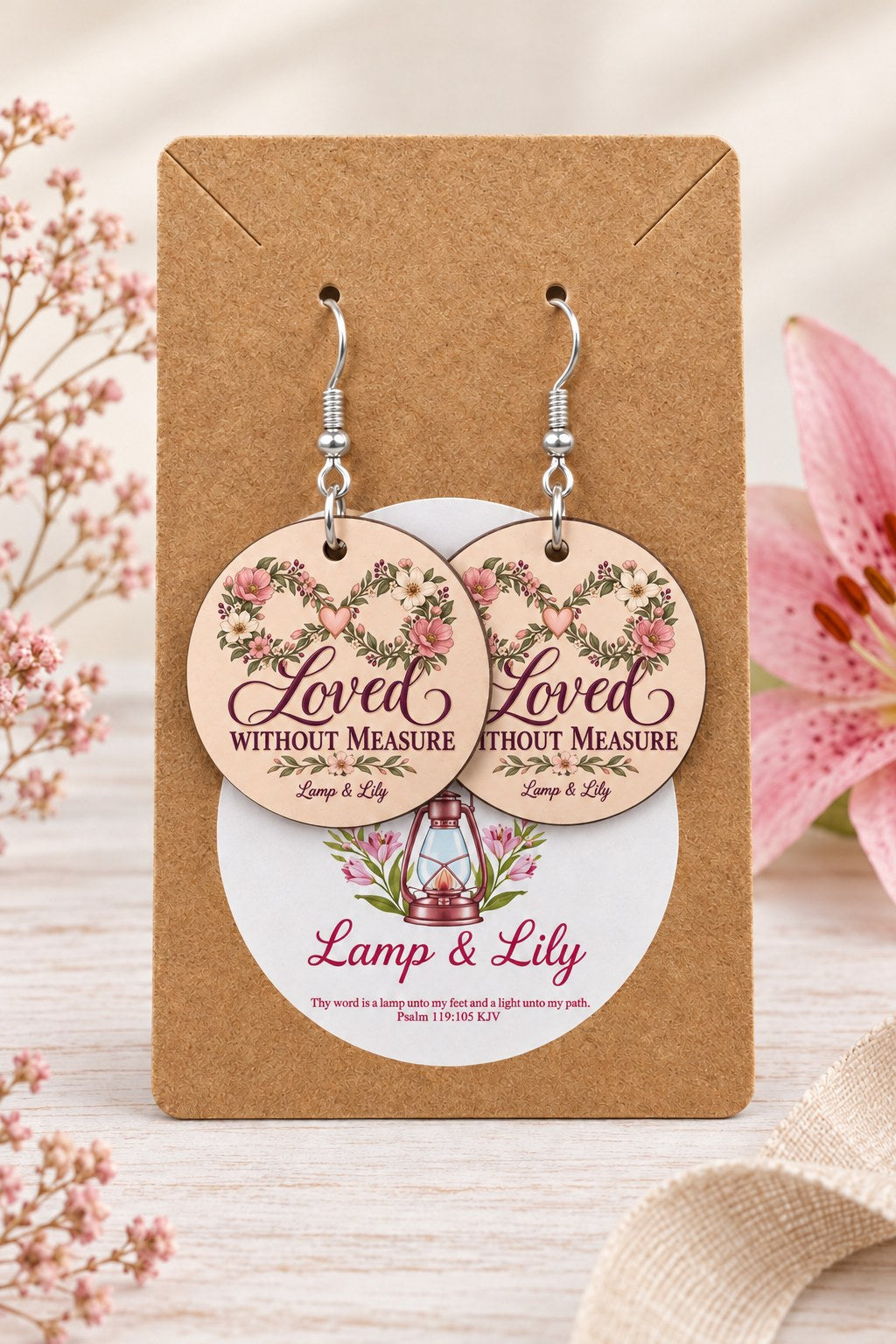 Loved without Measure round Lamp & Lily earrings on silver hooks displayed on a kraft earring card