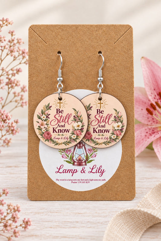 Be Still and Know round Lamp & Lily earrings on silver hooks displayed on a kraft earring card