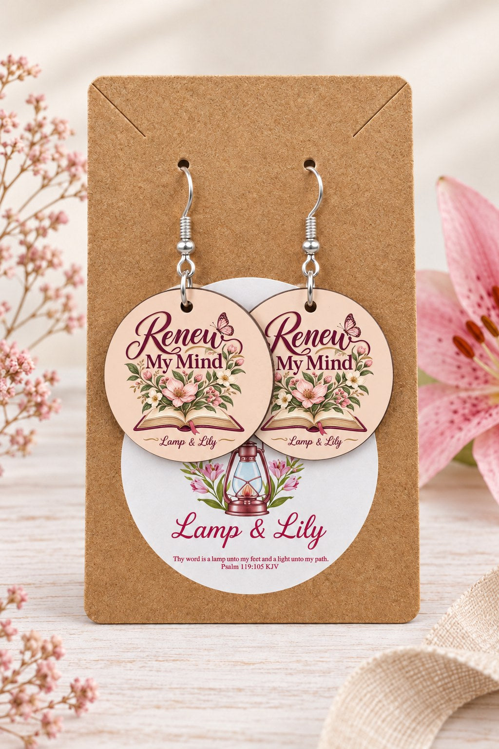 Renew my Mind round Lamp & Lily earrings on silver hooks displayed on a kraft earring card