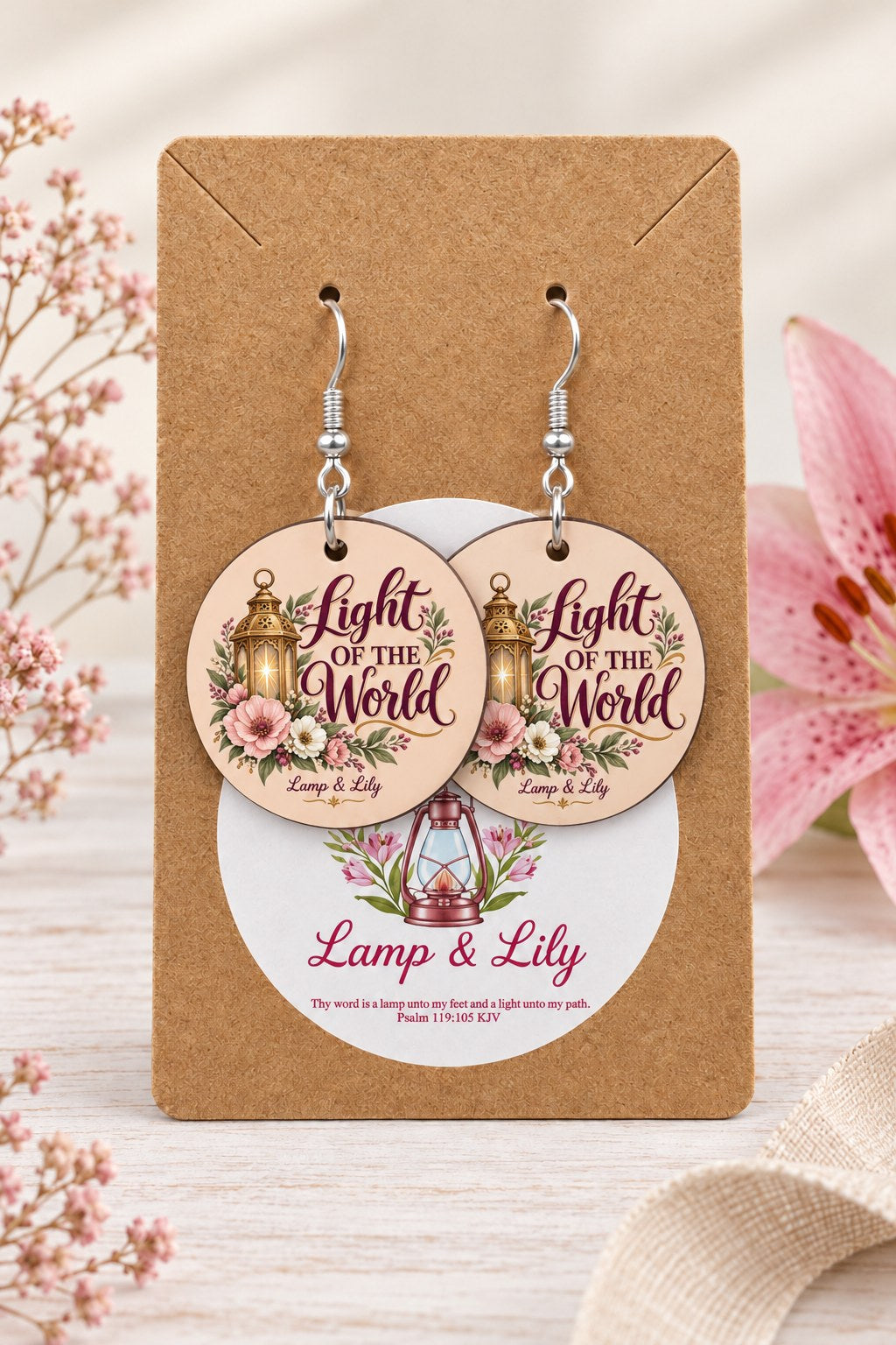 Light of the World round Lamp & Lily earrings on silver hooks displayed on a kraft earring card