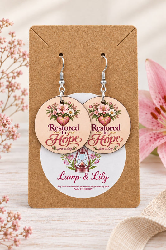 Restored in Hope round Lamp & Lily earrings on silver hooks displayed on a kraft earring card